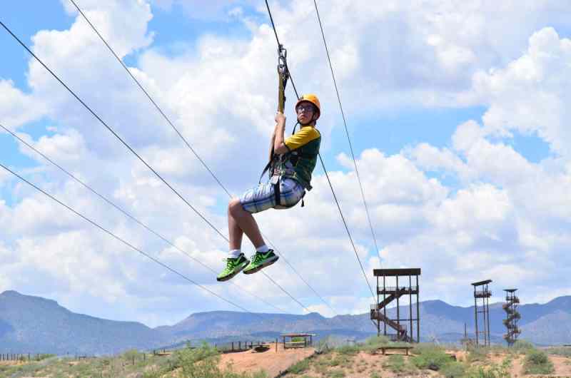 A boy on the final zip line of the Predator Zip Line Tour