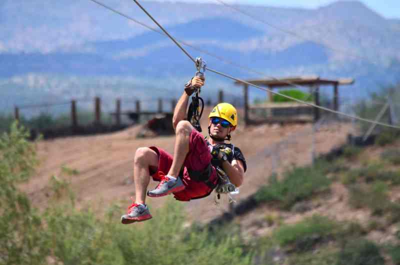 A man suspended from a zip line