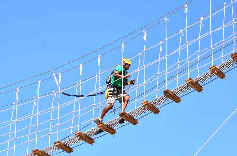 A man crossing the suspension bridge