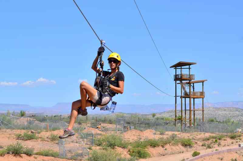 A woman approaching the tower from the zip line