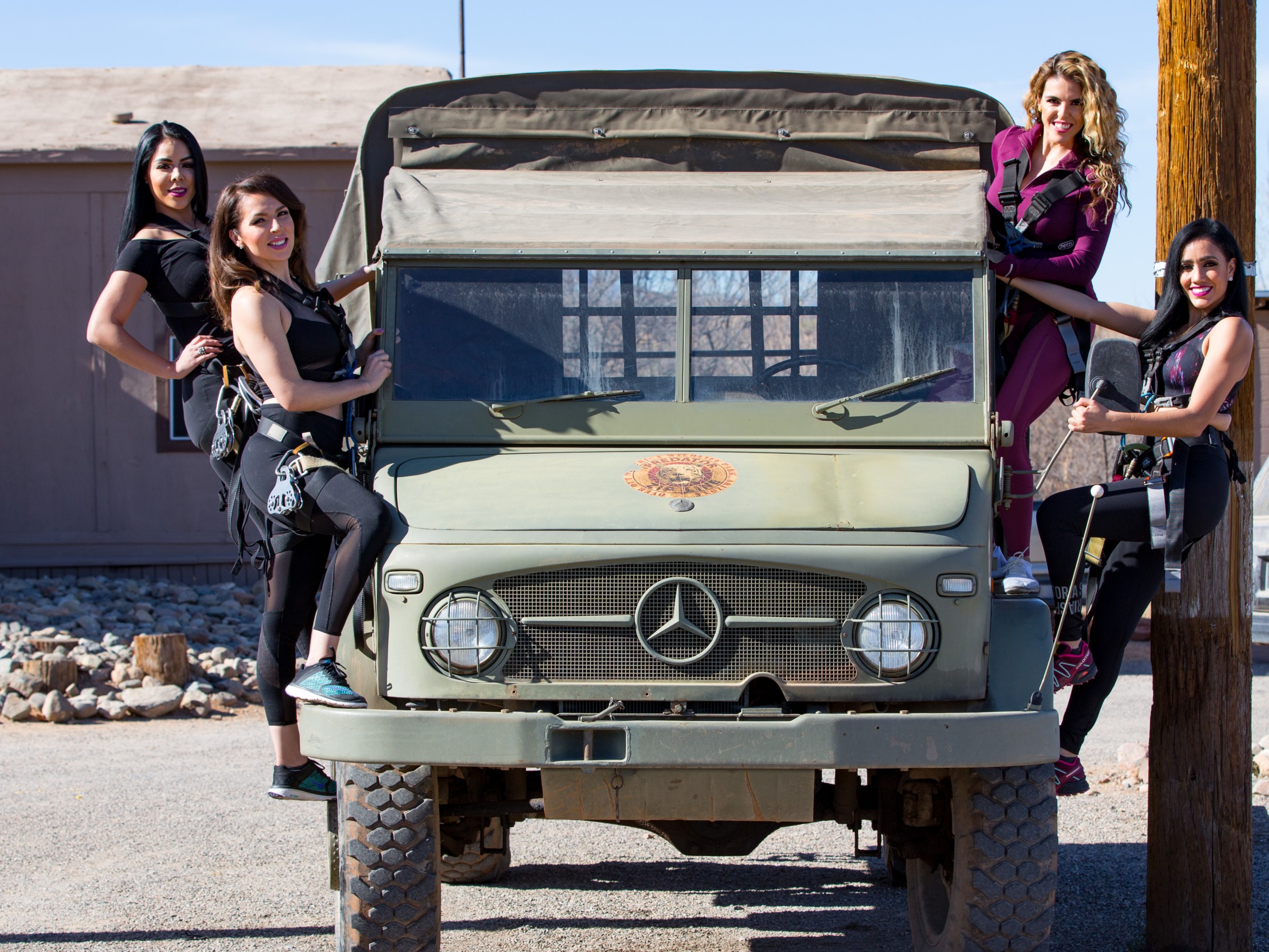 Four zip liners posing on the Predator Zip Lines truck