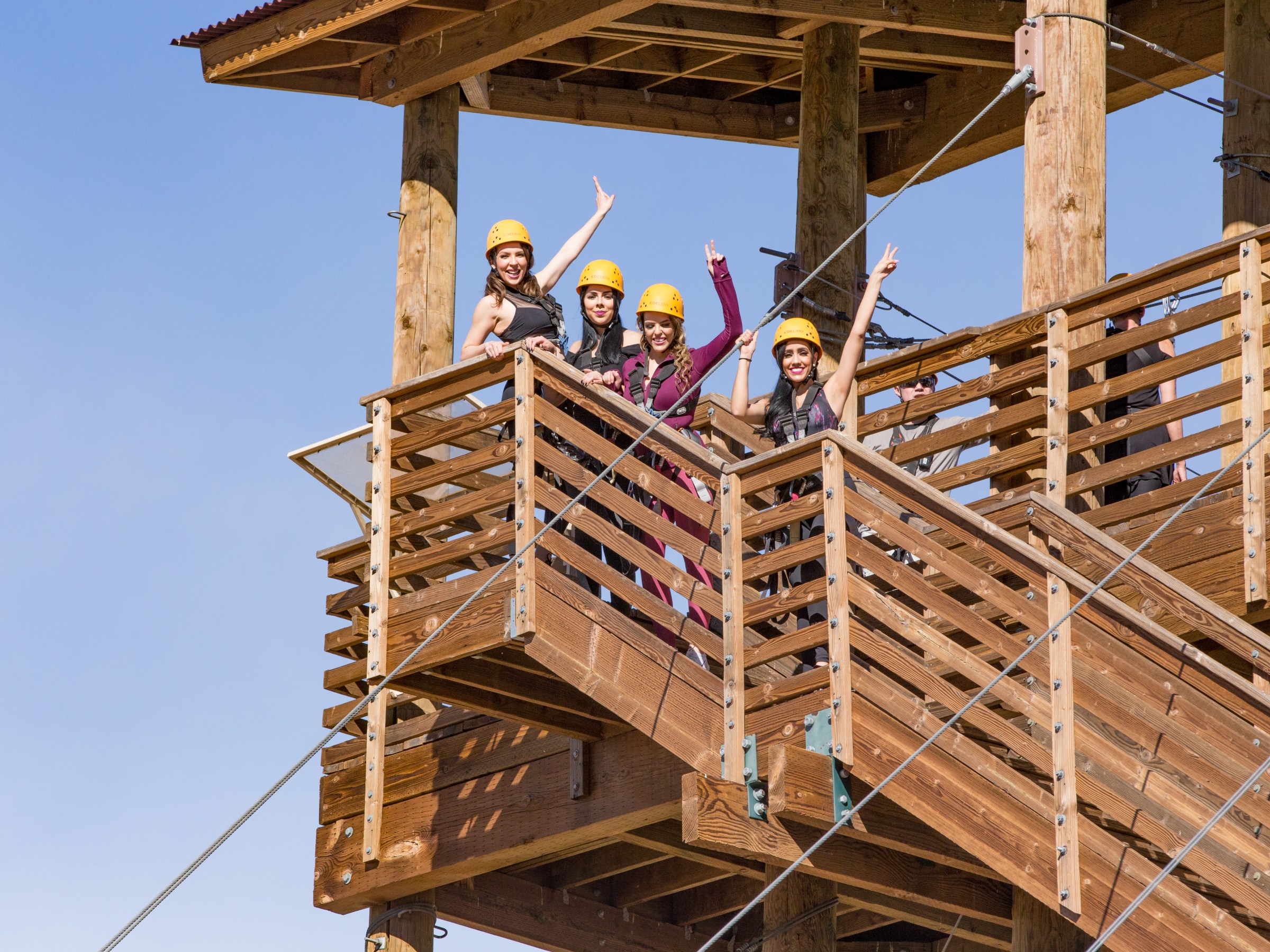 Four zip liners on the stairs of a tower